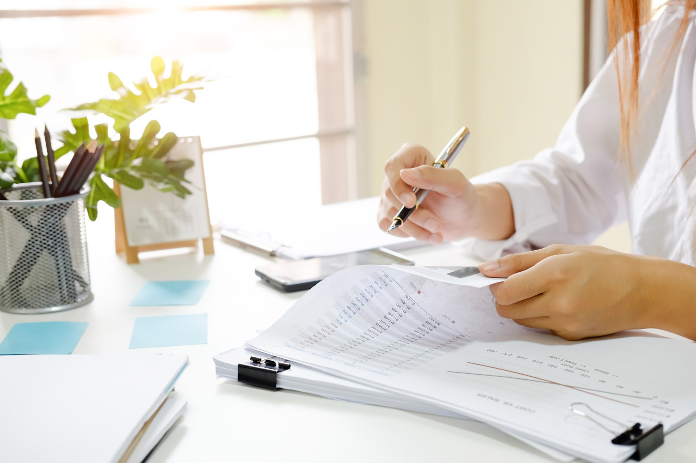 Documents and pen on desk to analyse risk