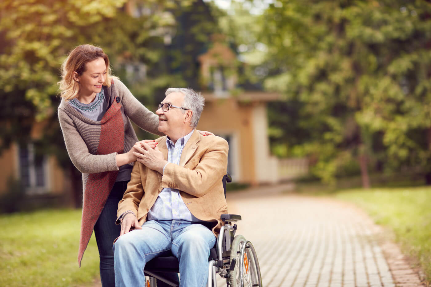 Woman caring for elderly in wheelchair